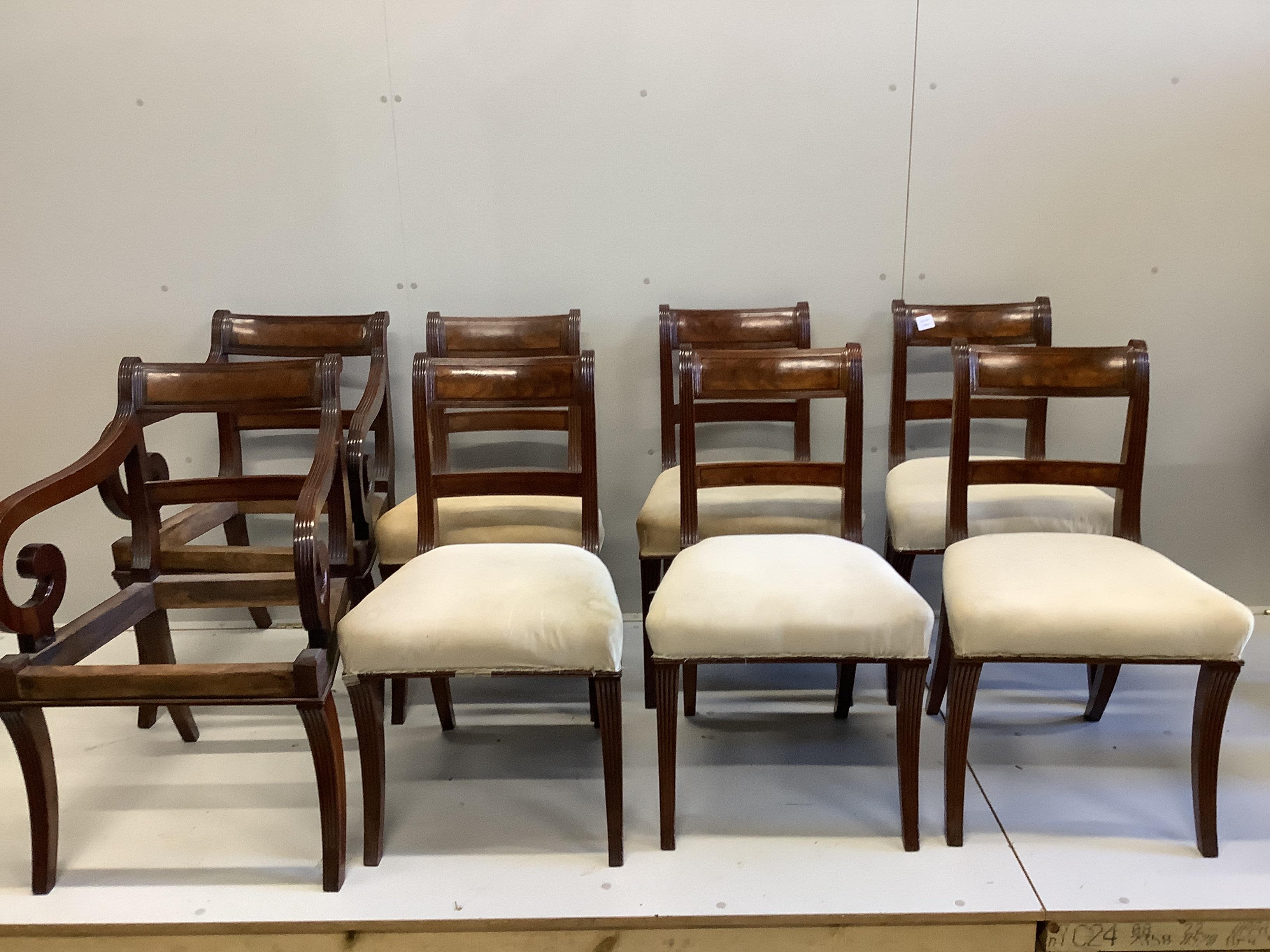 A set of six Regency mahogany dining chairs and two later elbow chairs lacking upholstery